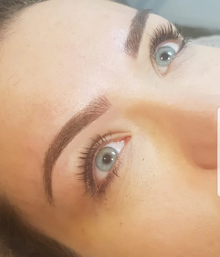 Shaped brows and curled lashes — brow work by Zoma Beauty
