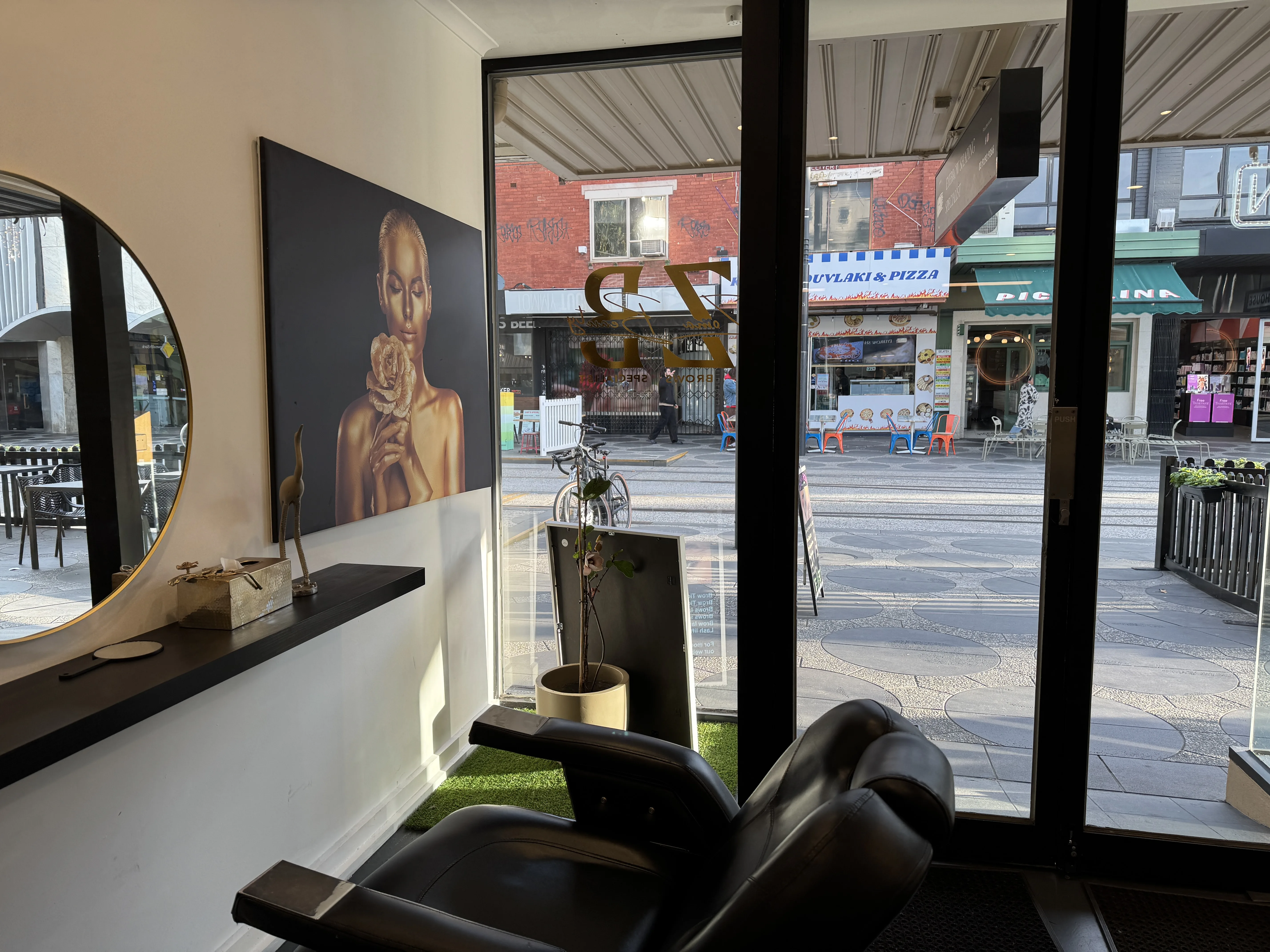 Studio interior looking out through glass to Acland Street shopfronts