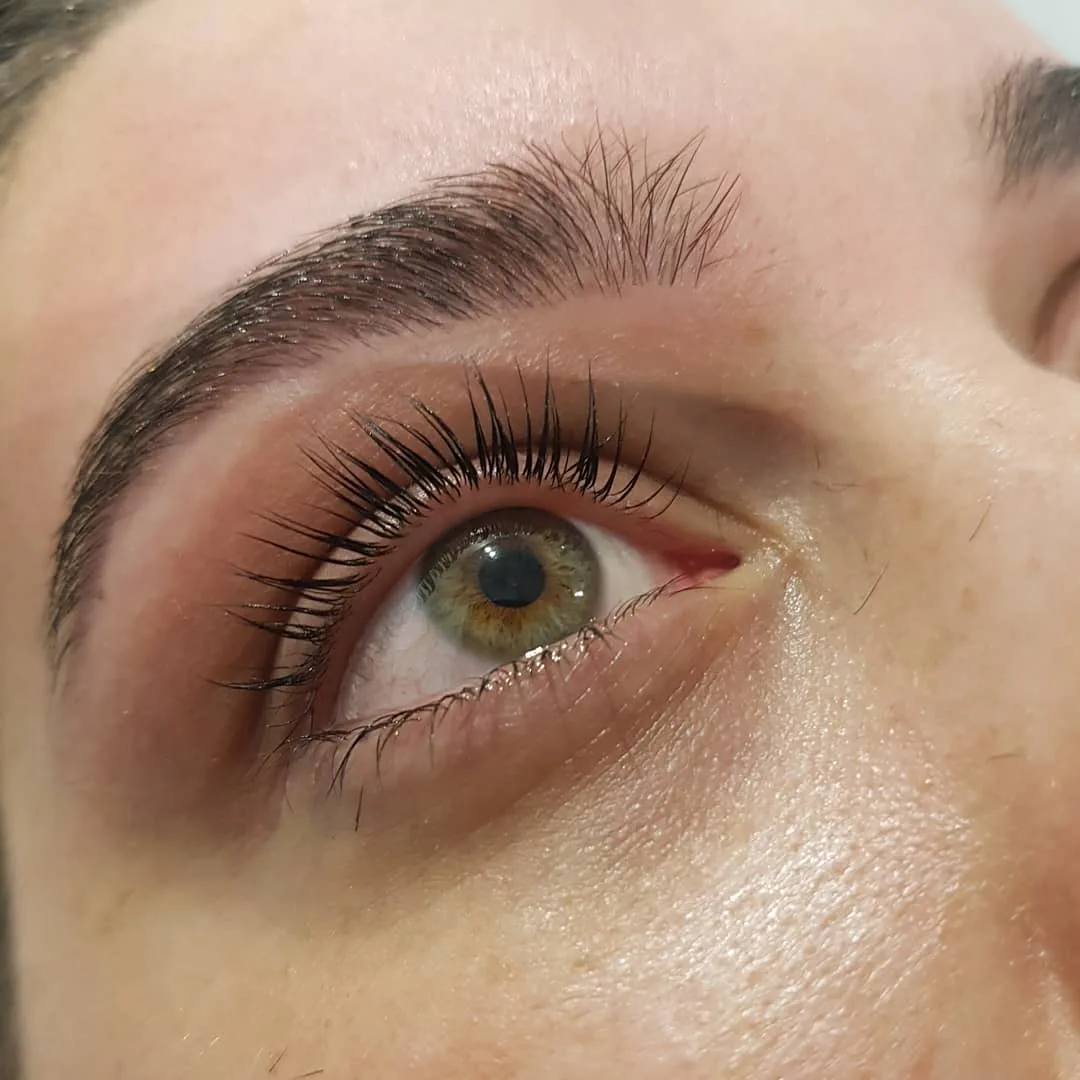 Lash lift and groomed brow over a green eye